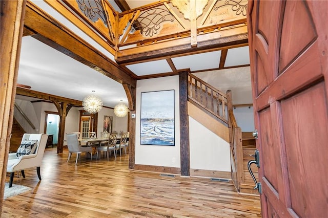 foyer entrance featuring a chandelier and wood finished floors