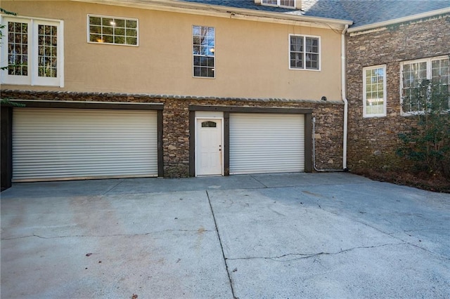 garage featuring concrete driveway