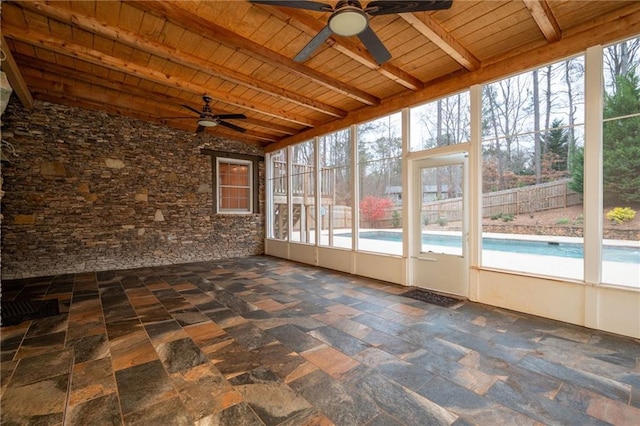 unfurnished sunroom featuring a ceiling fan and healthy amount of natural light