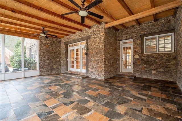 unfurnished sunroom featuring french doors and beamed ceiling