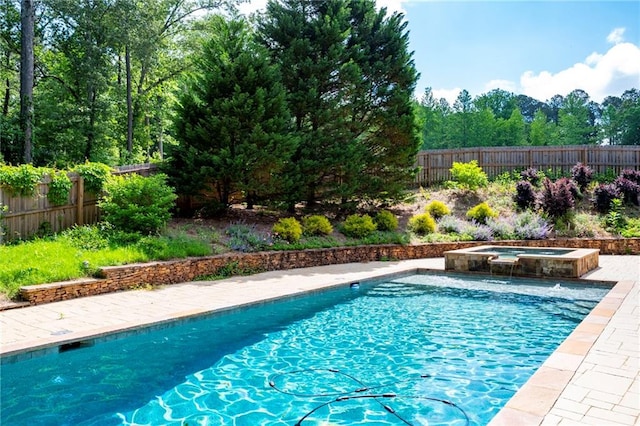view of swimming pool with a fenced backyard and an in-ground hot tub