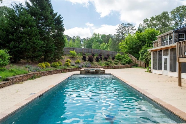 view of swimming pool featuring a fenced backyard, a patio, a sunroom, and a pool with connected hot tub