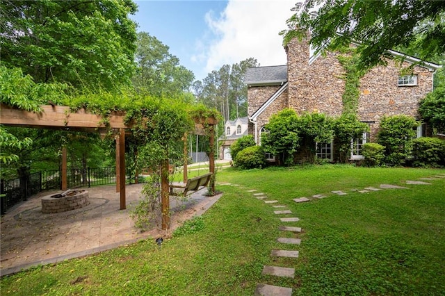 view of yard featuring a fire pit, a patio, and a pergola