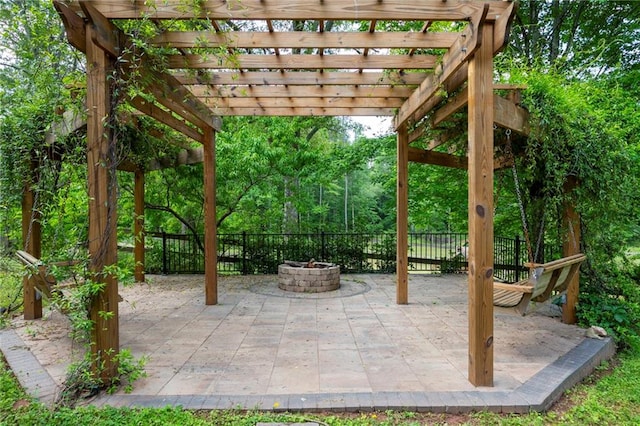 view of patio / terrace with a fire pit, fence, and a pergola