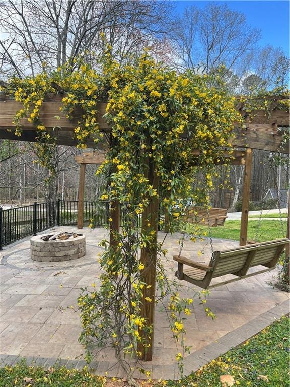 view of patio / terrace featuring an outdoor fire pit, a pergola, and fence
