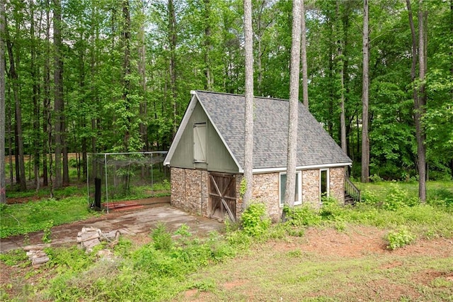 view of barn with a forest view