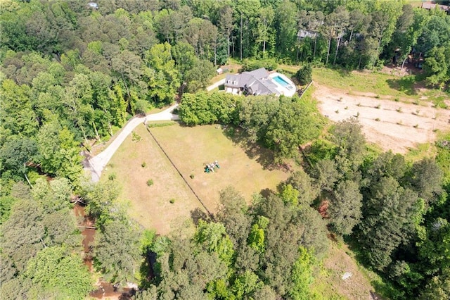 aerial view of property's location with a forest
