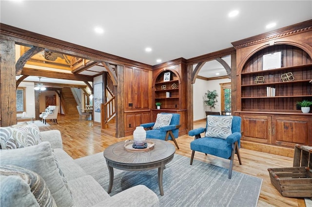 living room with arched walkways, crown molding, stairs, ceiling fan, and recessed lighting