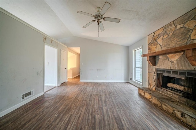 unfurnished living room featuring lofted ceiling, a fireplace, visible vents, baseboards, and dark wood-style floors