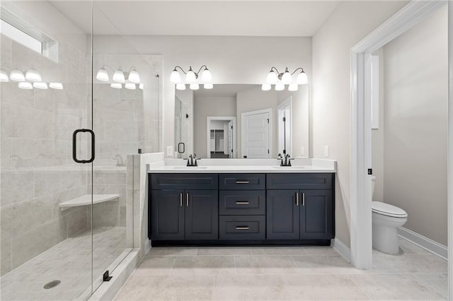 bathroom featuring vanity, toilet, and a shower with door