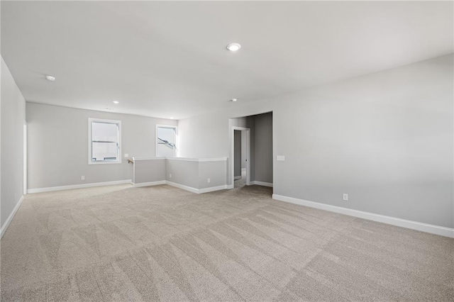 unfurnished room with light carpet