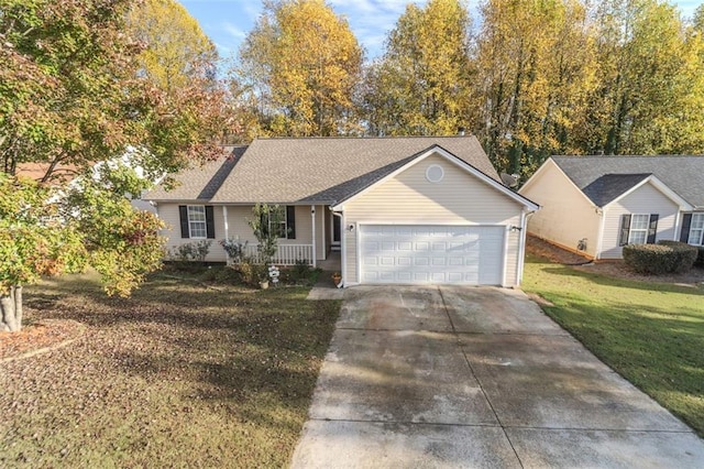 ranch-style home with covered porch, a garage, and a front yard