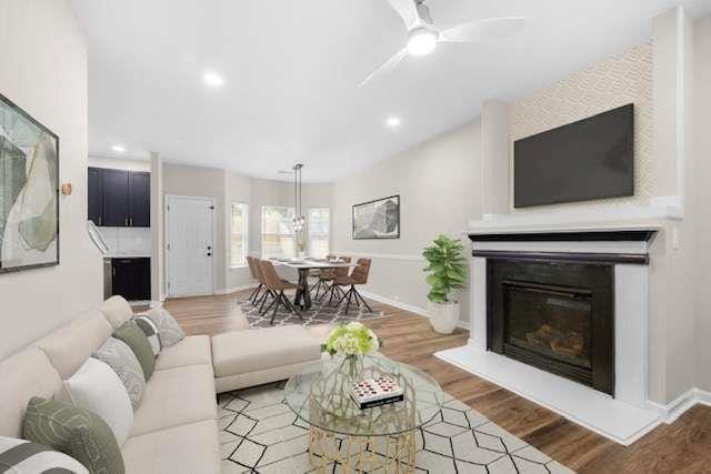 living room featuring hardwood / wood-style floors and ceiling fan