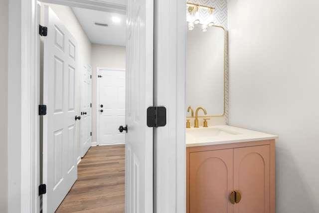 bathroom with vanity and hardwood / wood-style floors