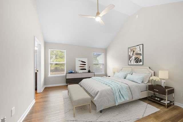 bedroom with hardwood / wood-style floors, high vaulted ceiling, and ceiling fan