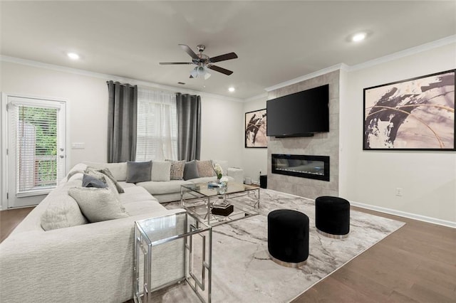 2227 Foley Park St, Snellville, GA 30078 - living room with wood finished floors, a ceiling fan, recessed lighting, crown molding, and a tiled fireplace