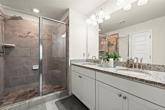 2227 Foley Park St, Snellville, GA 30078 - bathroom with double vanity, a stall shower, and tile patterned flooring