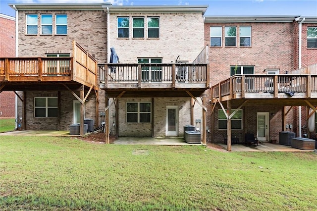 2227 Foley Park St, Snellville, GA 30078 - rear view of house featuring a patio, brick siding, and a lawn