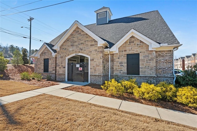 2227 Foley Park St, Snellville, GA 30078 - view of front of home featuring a shingled roof and stone siding