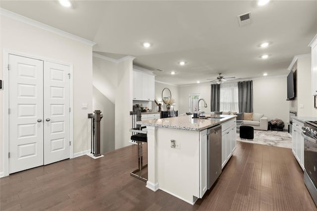 2227 Foley Park St, Snellville, GA 30078 - kitchen with crown molding, stainless steel dishwasher, open floor plan, recessed lighting, and white cabinets