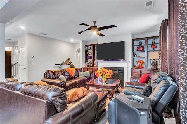 3259 Baylor Cir, Mcdonough, GA 30253 - living area featuring a ceiling fan, arched walkways, and a fireplace
