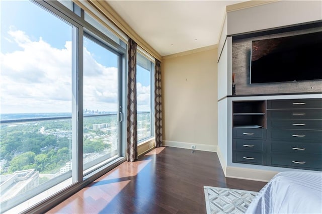 unfurnished bedroom with baseboards, dark wood-style floors, and crown molding