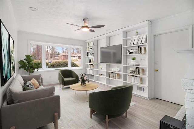 living room featuring ceiling fan, built in features, and light wood-type flooring