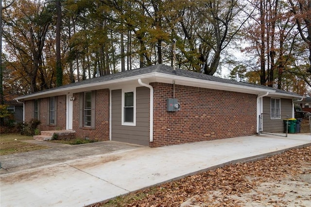 view of side of property with brick siding and driveway