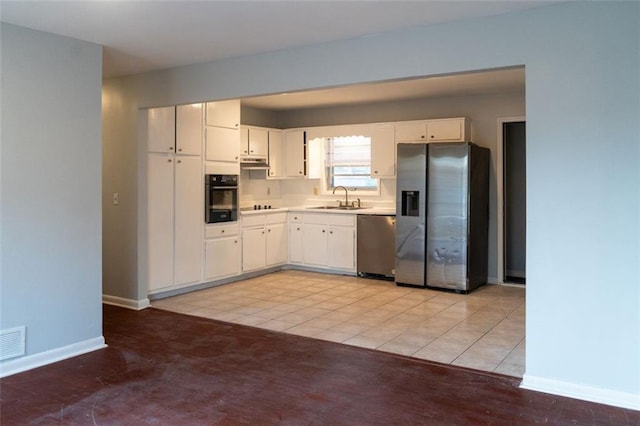 kitchen featuring black appliances, light countertops, baseboards, and a sink