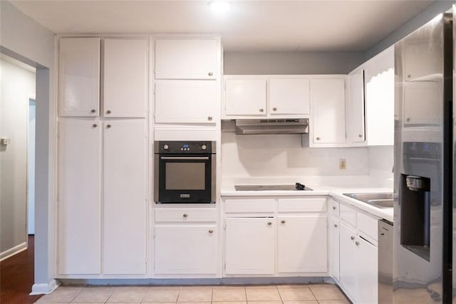 kitchen featuring black appliances, under cabinet range hood, light countertops, white cabinetry, and a sink