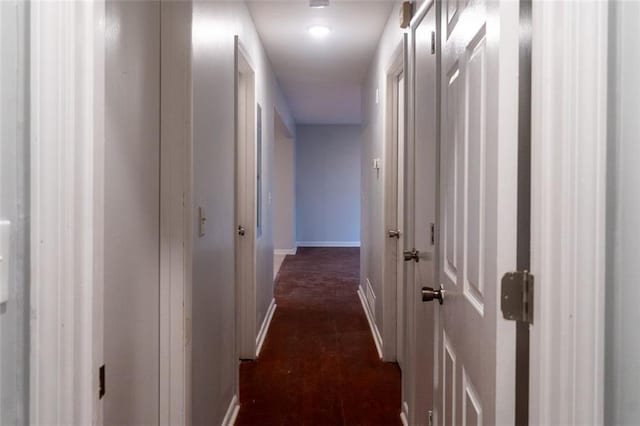 hall featuring baseboards