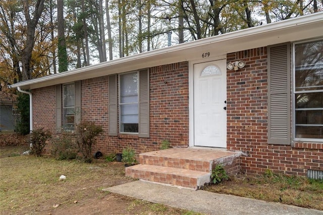 view of exterior entry with brick siding