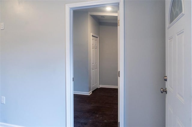 hallway with baseboards and dark wood-style flooring