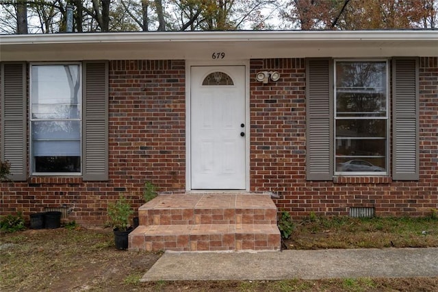 entrance to property with crawl space and brick siding