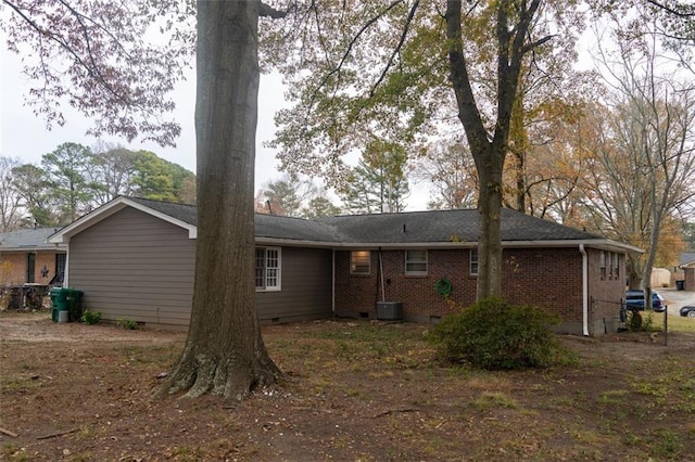 rear view of property featuring crawl space, brick siding, and central AC