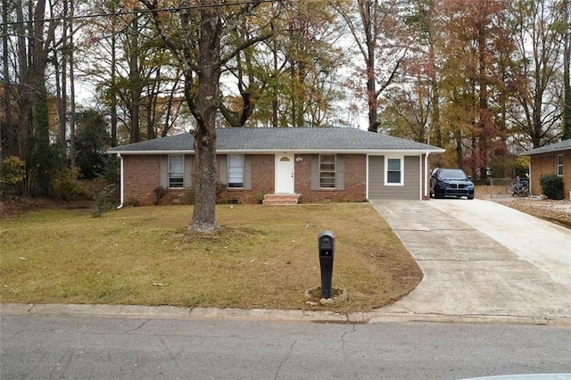 single story home featuring brick siding, a front lawn, and driveway