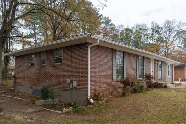 view of property exterior with brick siding