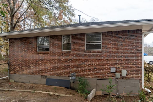 view of home's exterior with brick siding and crawl space