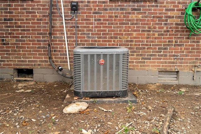 exterior details with brick siding and central air condition unit