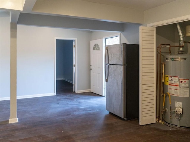 interior space with gas water heater, baseboards, dark wood finished floors, and freestanding refrigerator