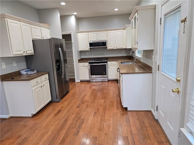 3773 Summer Rose Dr, Atlanta, GA 30341 - kitchen with stainless steel appliances, a sink, light wood-style floors, white cabinetry, and recessed lighting