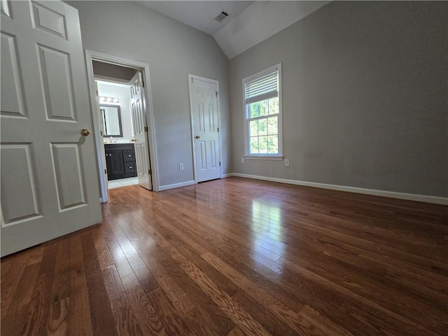 3773 Summer Rose Dr, Atlanta, GA 30341 - unfurnished bedroom featuring lofted ceiling, dark wood-type flooring, baseboards, and ensuite bathroom