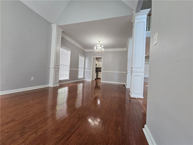 3773 Summer Rose Dr, Atlanta, GA 30341 - unfurnished living room with ornate columns, a chandelier, hardwood / wood-style floors, baseboards, and crown molding