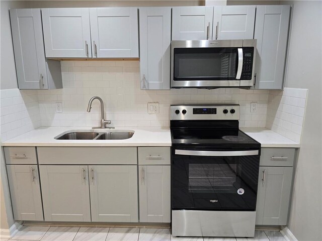 3773 Summer Rose Dr, Atlanta, GA 30341 - kitchen featuring appliances with stainless steel finishes, a sink, gray cabinets, and light countertops