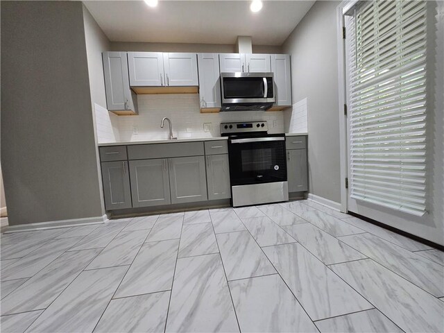 3773 Summer Rose Dr, Atlanta, GA 30341 - kitchen featuring appliances with stainless steel finishes, gray cabinets, baseboards, and backsplash