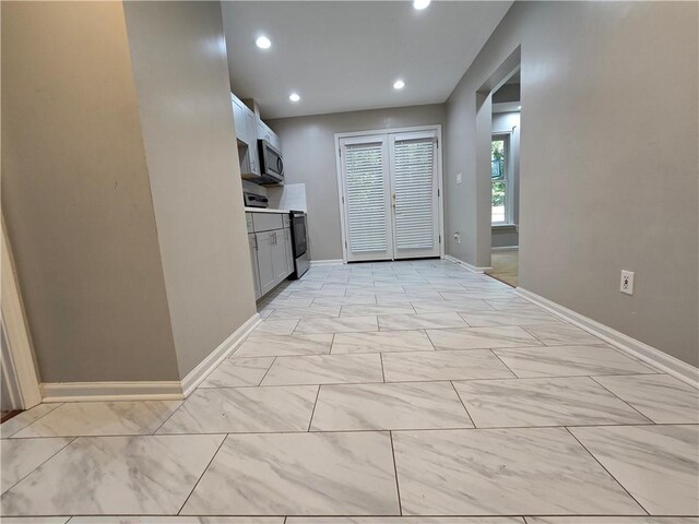3773 Summer Rose Dr, Atlanta, GA 30341 - kitchen featuring range with electric stovetop, stainless steel microwave, baseboards, recessed lighting, and light marble finish flooring