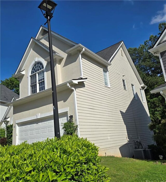3773 Summer Rose Dr, Atlanta, GA 30341 - view of home's exterior featuring a garage and stucco siding