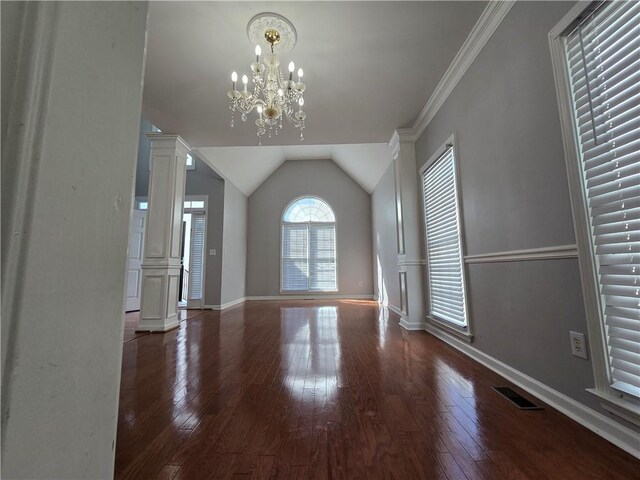 3773 Summer Rose Dr, Atlanta, GA 30341 - unfurnished living room with wood-type flooring, a chandelier, lofted ceiling, baseboards, and decorative columns