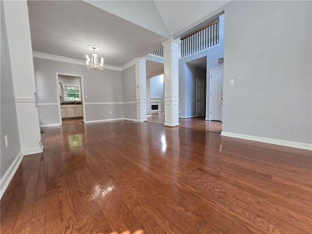 3773 Summer Rose Dr, Atlanta, GA 30341 - unfurnished room with decorative columns, a chandelier, hardwood / wood-style floors, crown molding, and baseboards