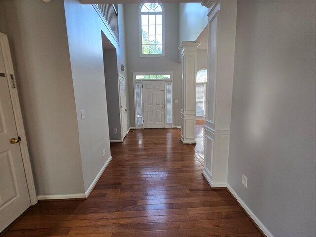 3773 Summer Rose Dr, Atlanta, GA 30341 - entryway featuring dark wood-style floors, a towering ceiling, baseboards, and ornate columns